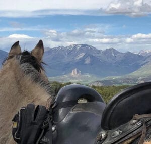 riding on horseback with mountain view