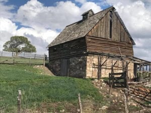 two-story wooden log house on hill